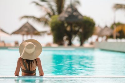 woman-relaxing-by-the-pool-in-a-luxury-hotel-resort-enjoying-perfect-beach-holiday-vacation.jpg